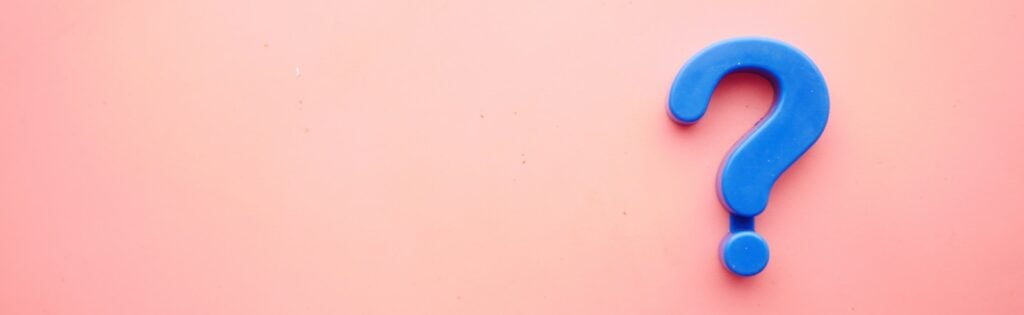 a blue question mark on a pink background